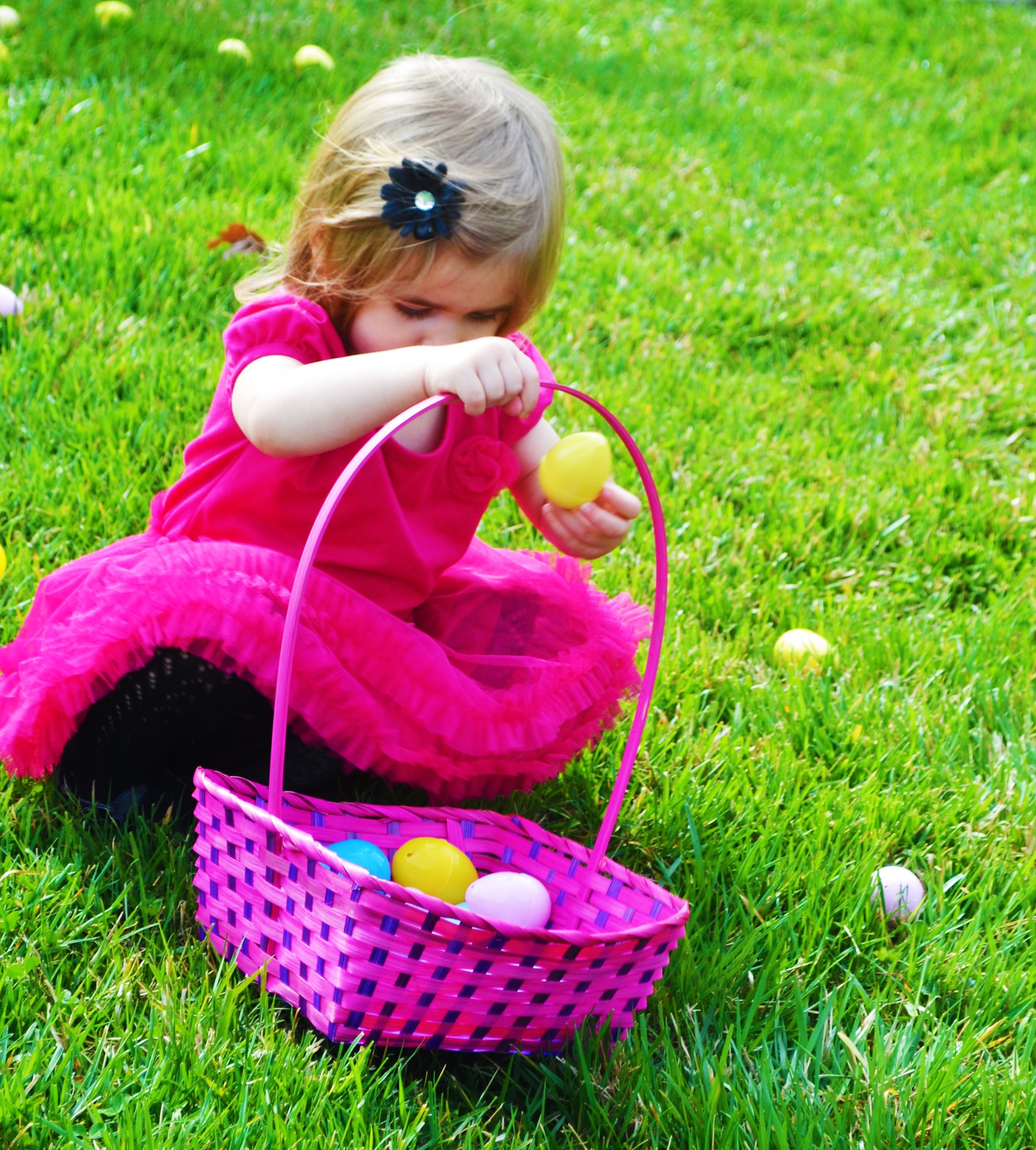 A child picks up an easter egg